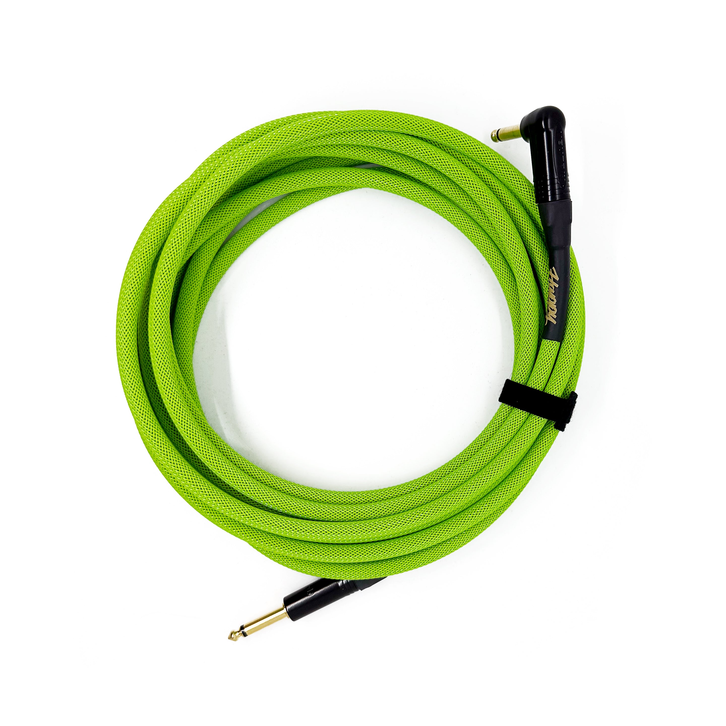Green guitar cable coiled on a white background